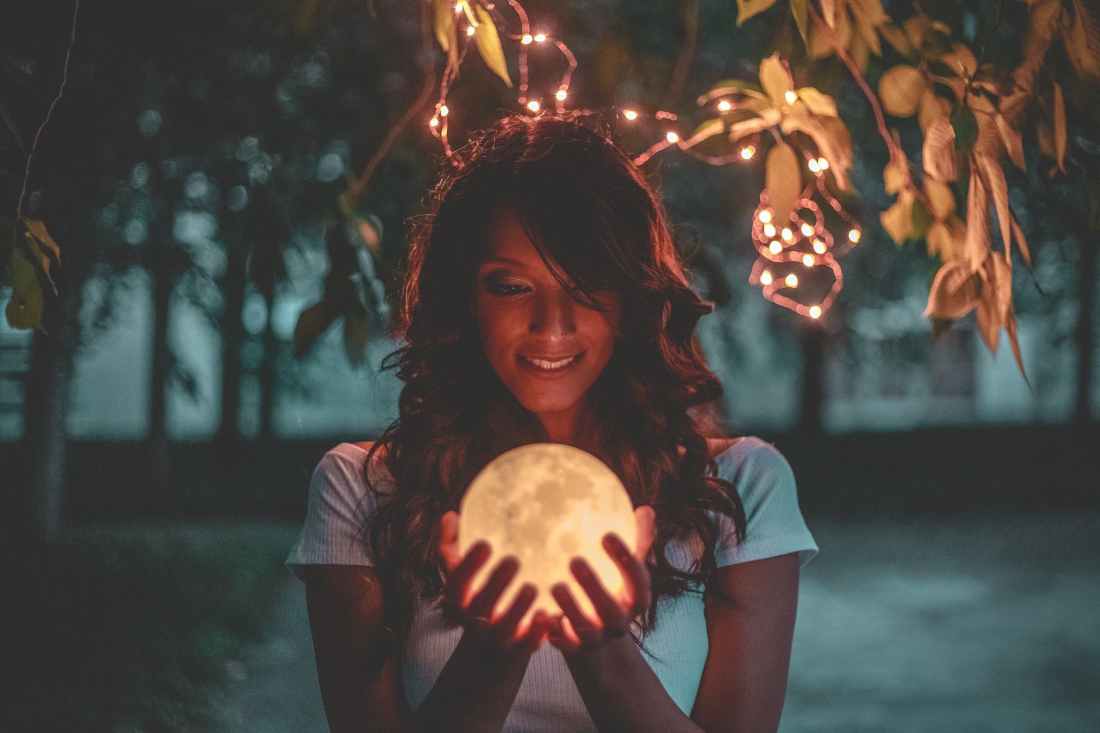 woman holding moon lamp